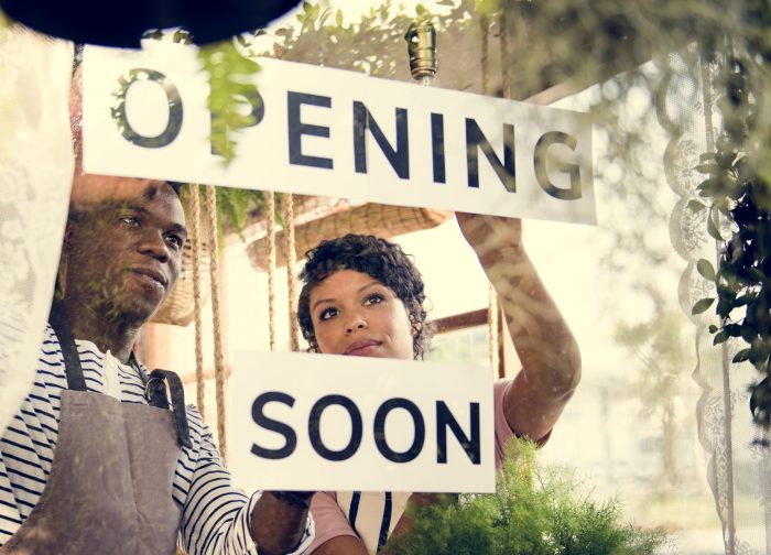 Couple,Showing,Opening,Soon,Paper,Sign